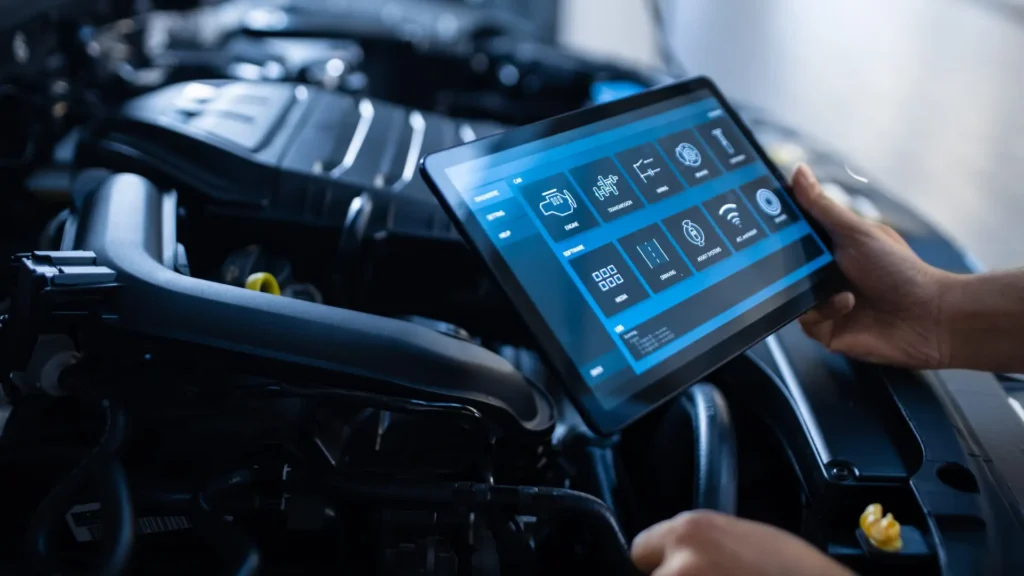 A mechanic reading fault codes with a tablet